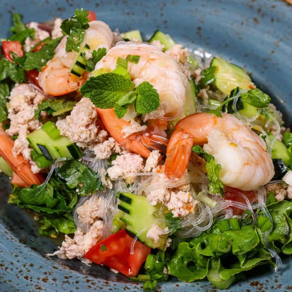NUA Thai glass noodle salad with shrimp, minced chicken, cucumber, tomatoes, and mint.