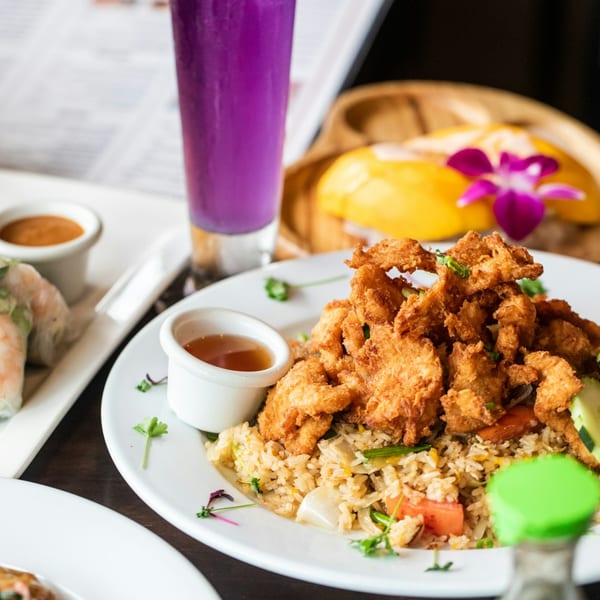 NUA Thai's fried chicken and fried rice, with spring rolls, purple drink, and mango sticky rice.